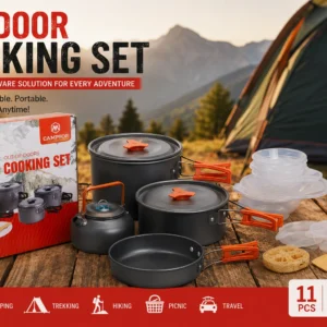 An outdoor cooking set displayed with various camping gear, including pots, utensils, and a portable stove.